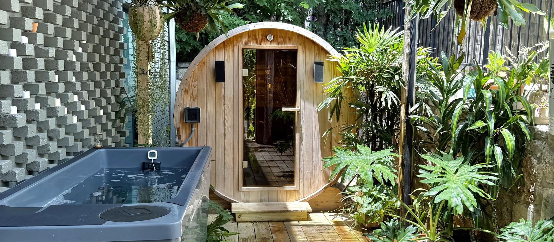 The Garden at Cøntrast in East Austin — a traditional barrel sauna and cold plunge surrounded by tropical planting