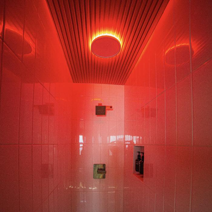 The vitamin-C shower in a private suite, lit red