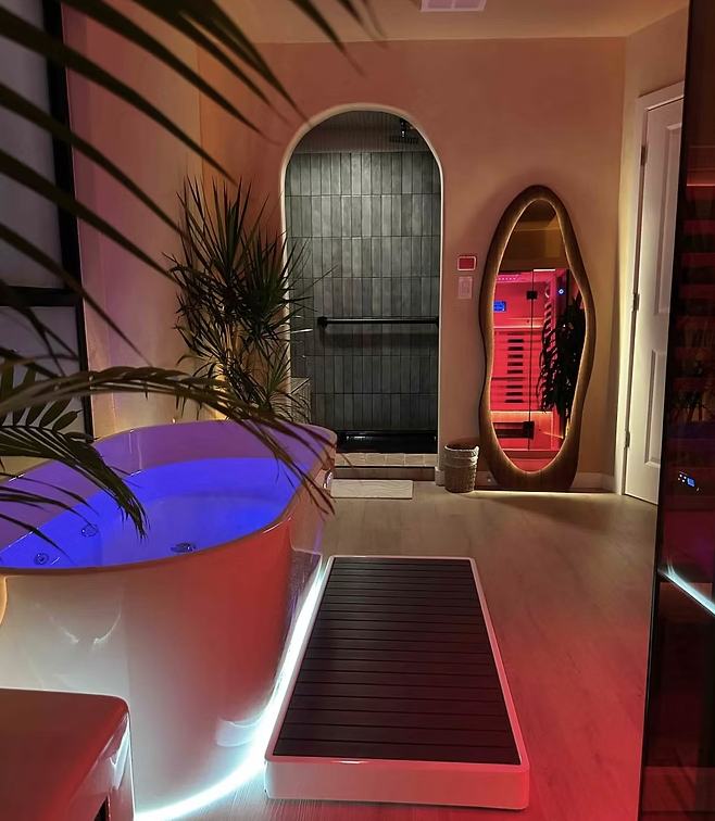 The arched shower and wavy mirror in a private suite